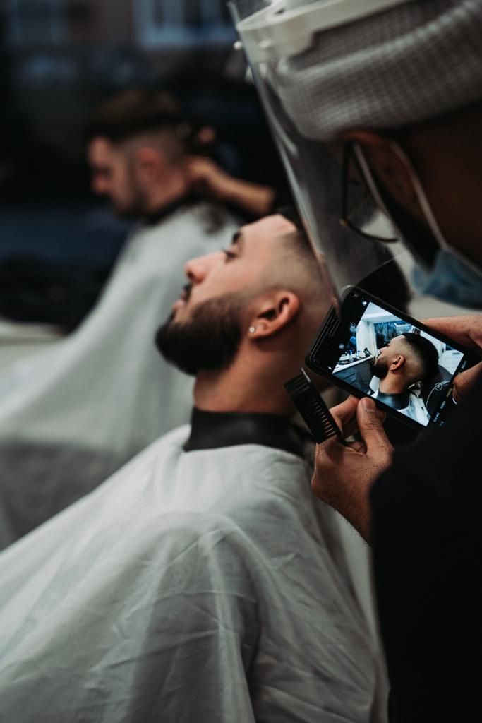 Beard trim in progress, Patel & Co